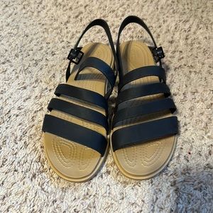 Crocs sandals size 7. Like new condition. Black with tan sole.